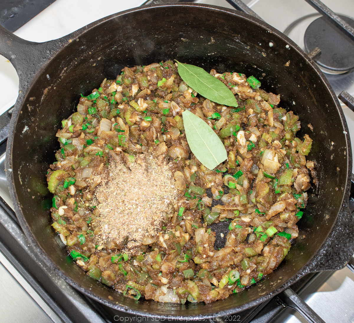 seasonings and bay leaves added to a cooked roux