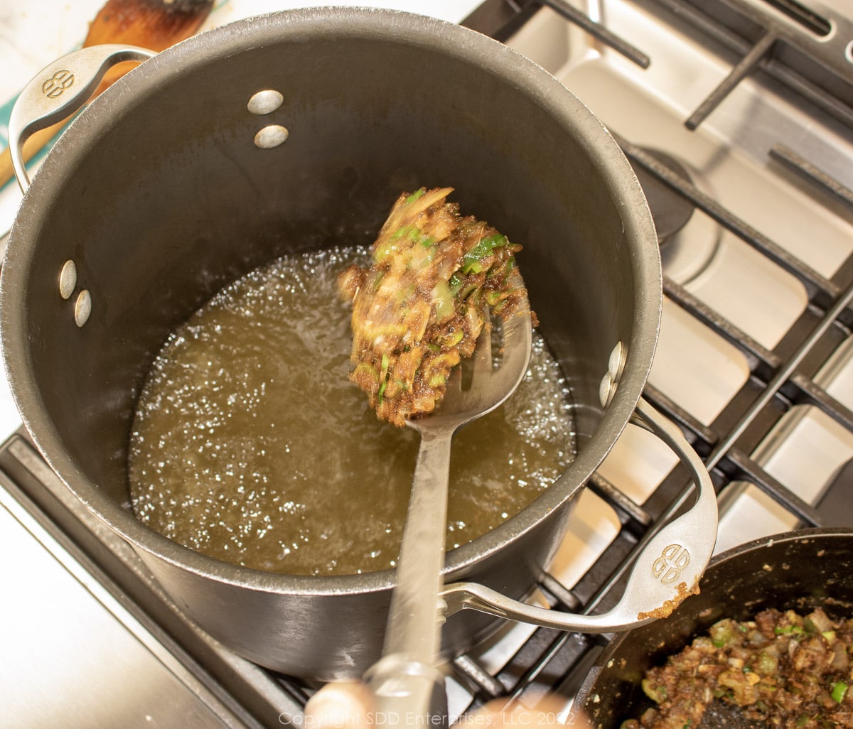 mixing roux with stock in a stockpot