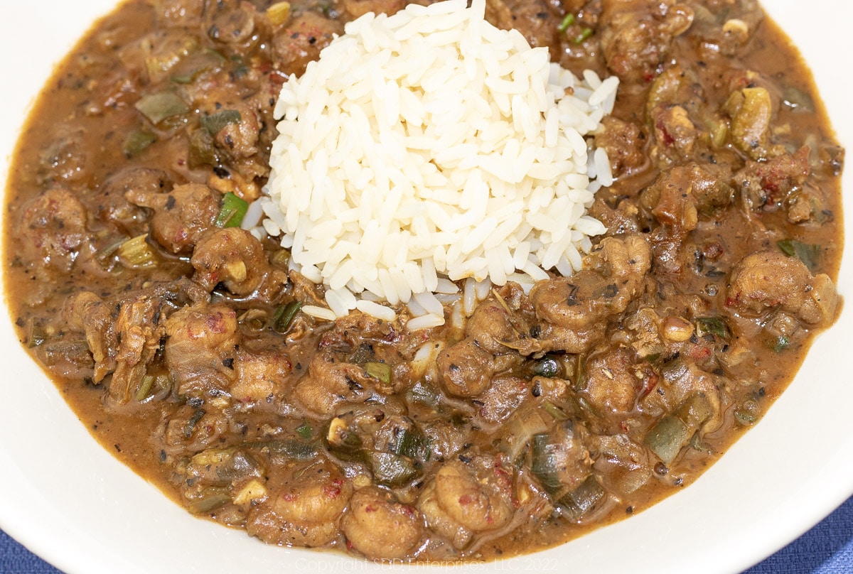 crawfish etouffee with rice in a white bowl