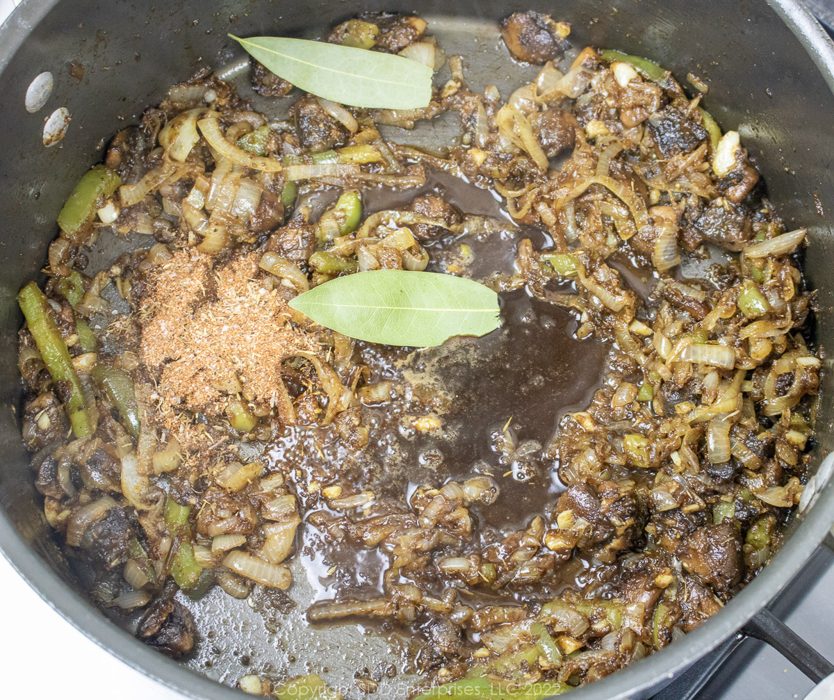 spices and seasoning added to sautéed vegetables