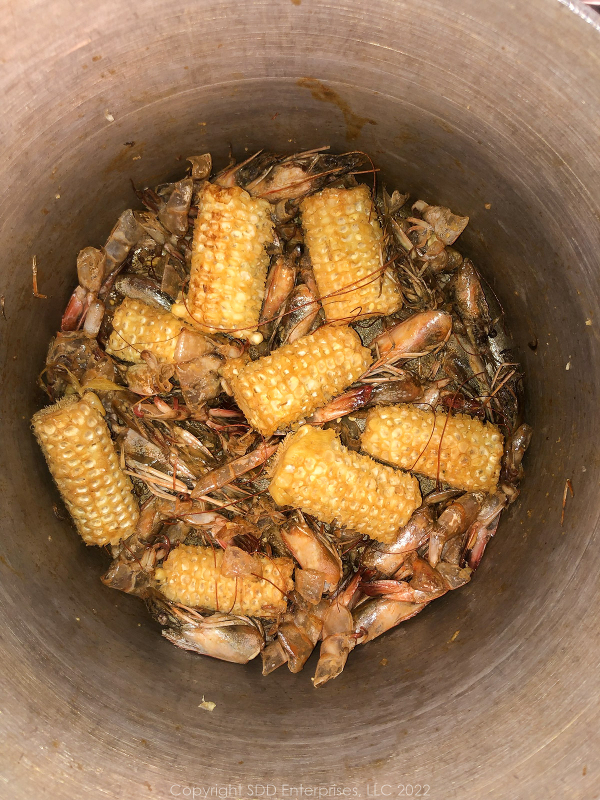 corn cobs added to shrimp shells in a stockpot