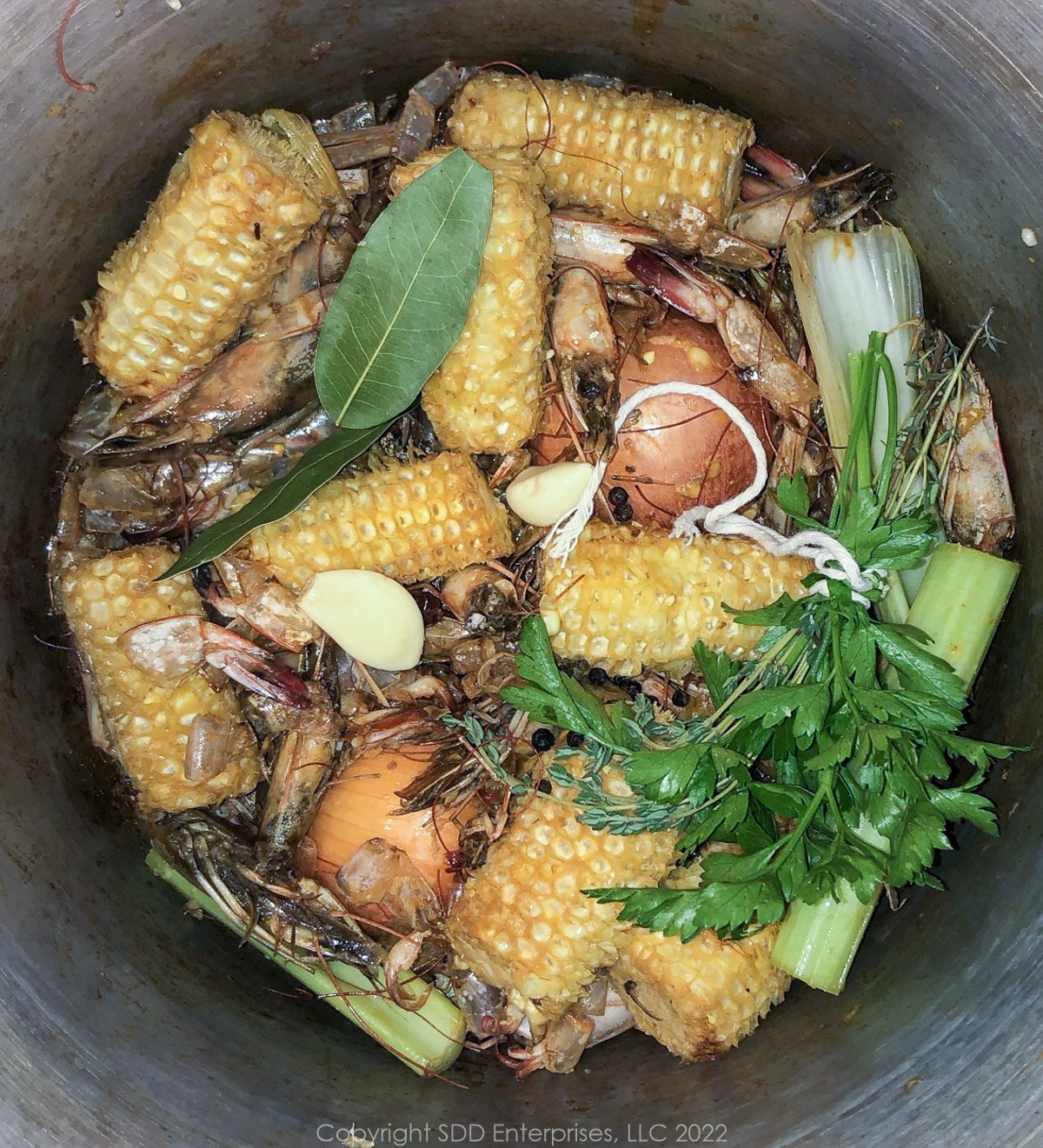 vegetables and shrimp shells in stockpot