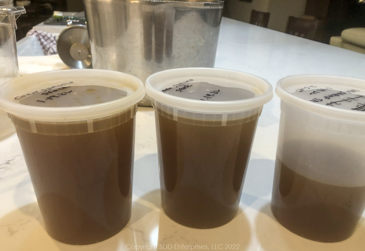 containers of homemade corn and shrimp stock