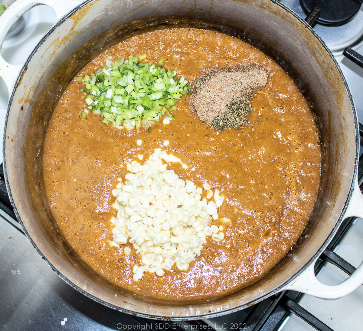 corn, herbs and green onions added to pureed bisque