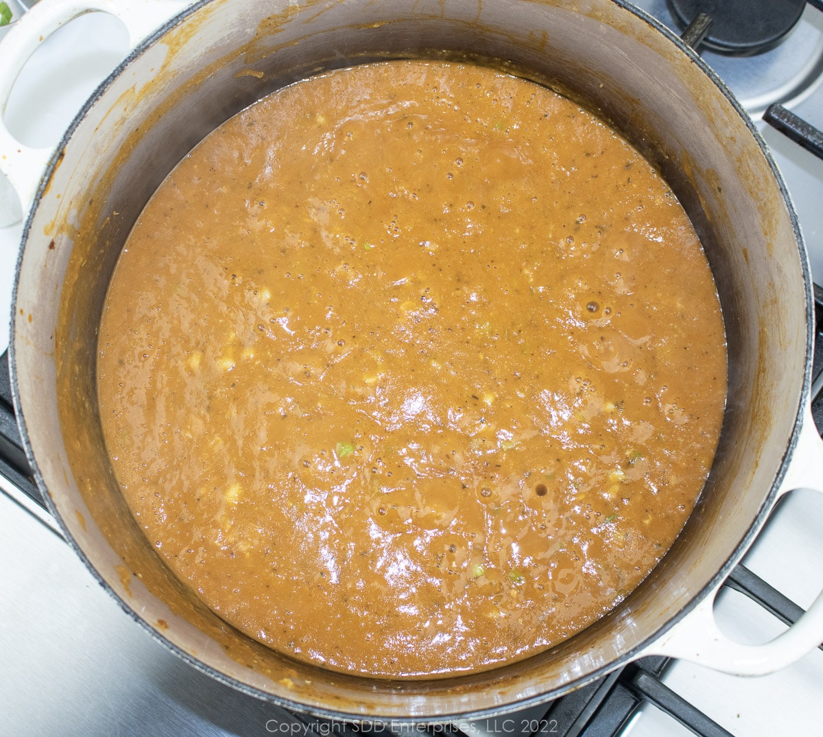 simmering pureed soup in a Dutch oven