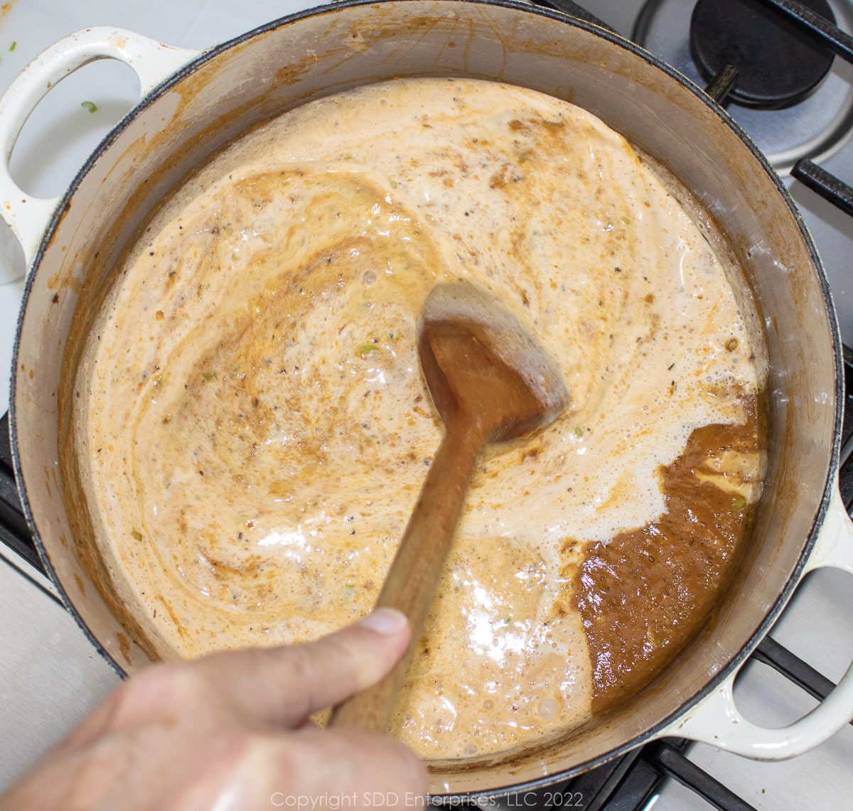 heavy cream added to pureed bisque in a Dutch oven