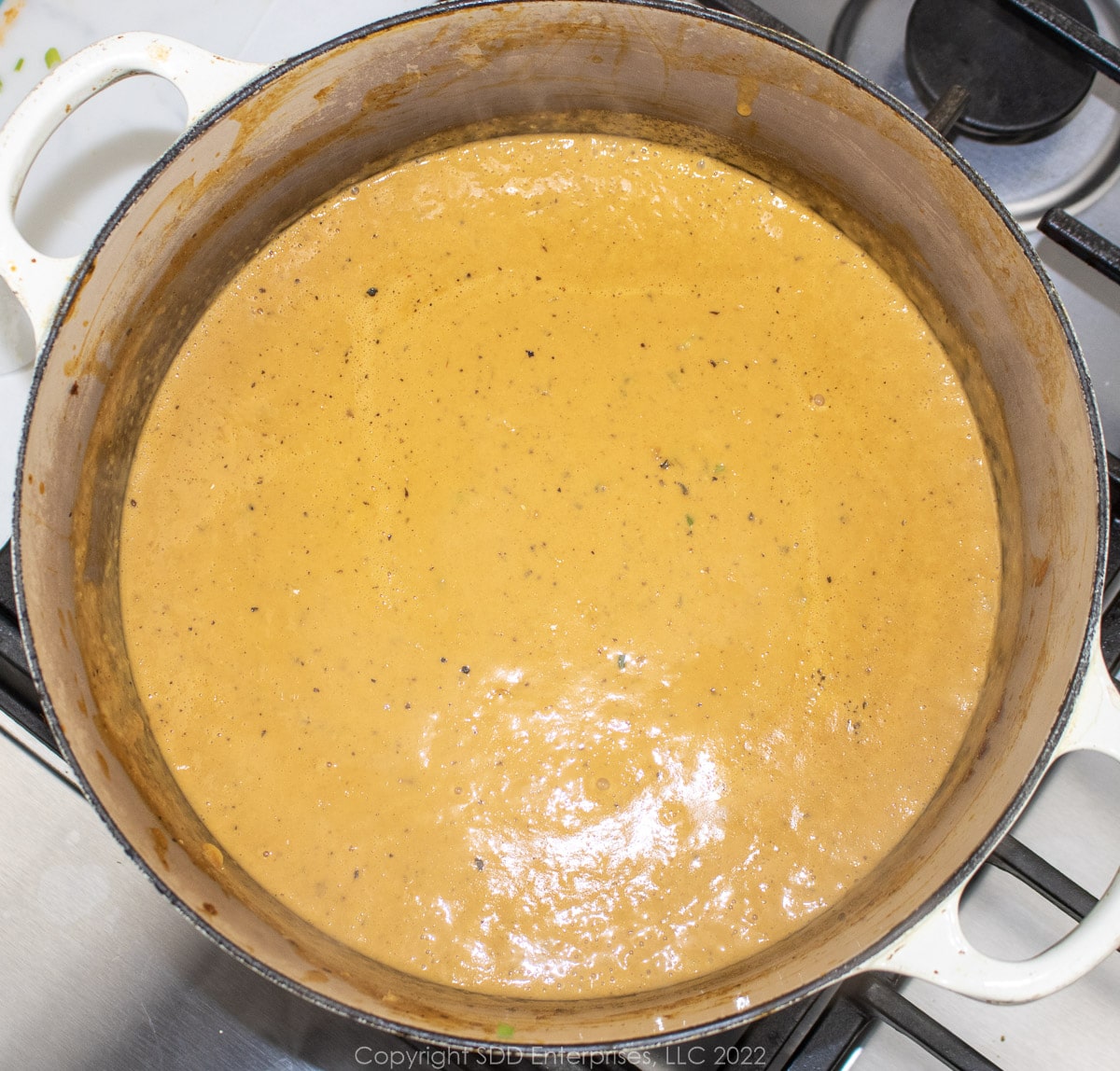 simmering pureed bisque in a Dutch oven