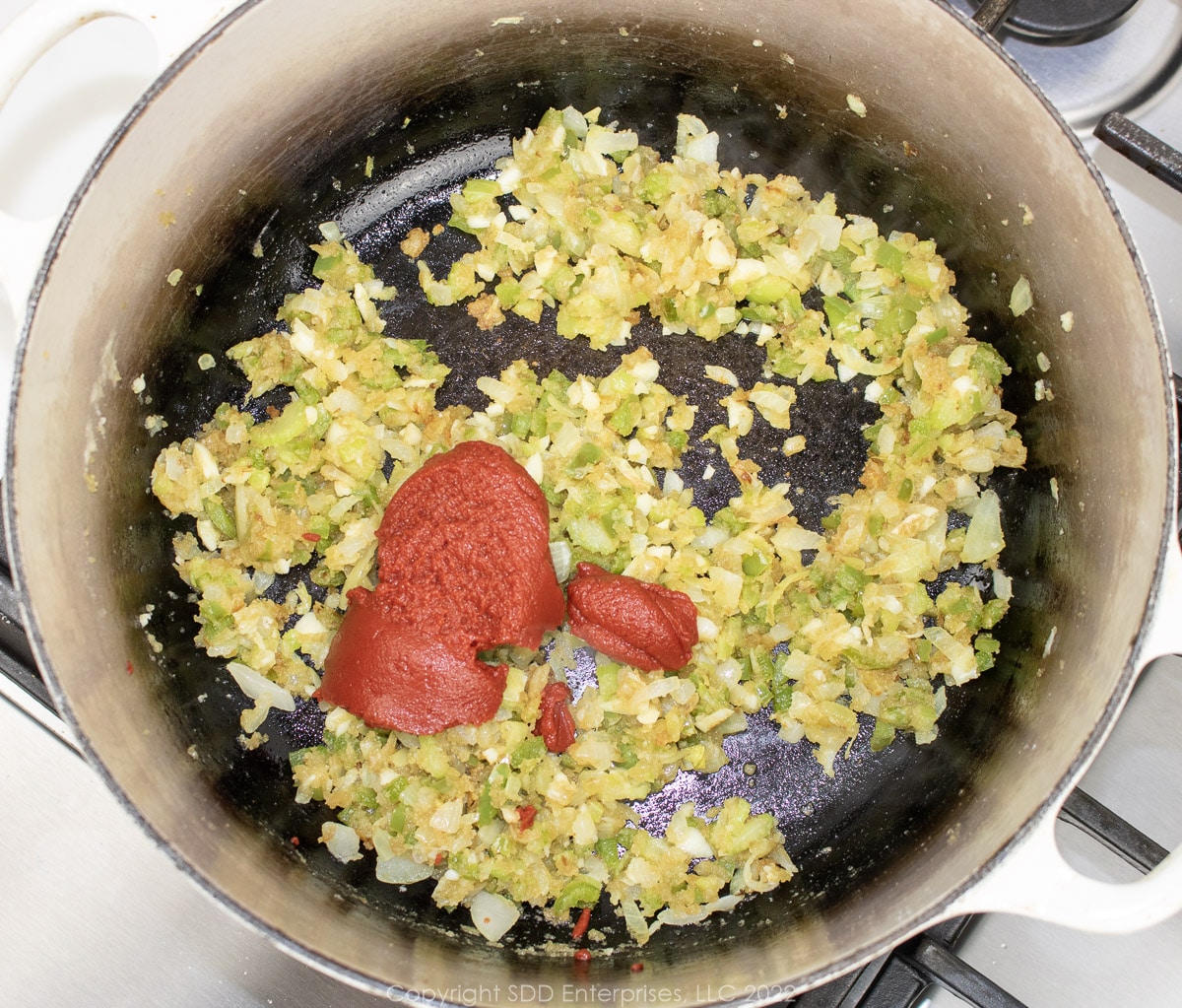 tomaoto paste with the trinity and roux in a Dutch oven