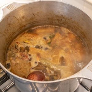 Homemade stock simmering in a stock pot.