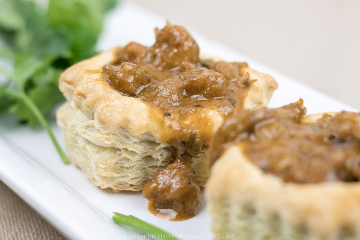 crawfish vol au vents on a white platter with parsley garnish