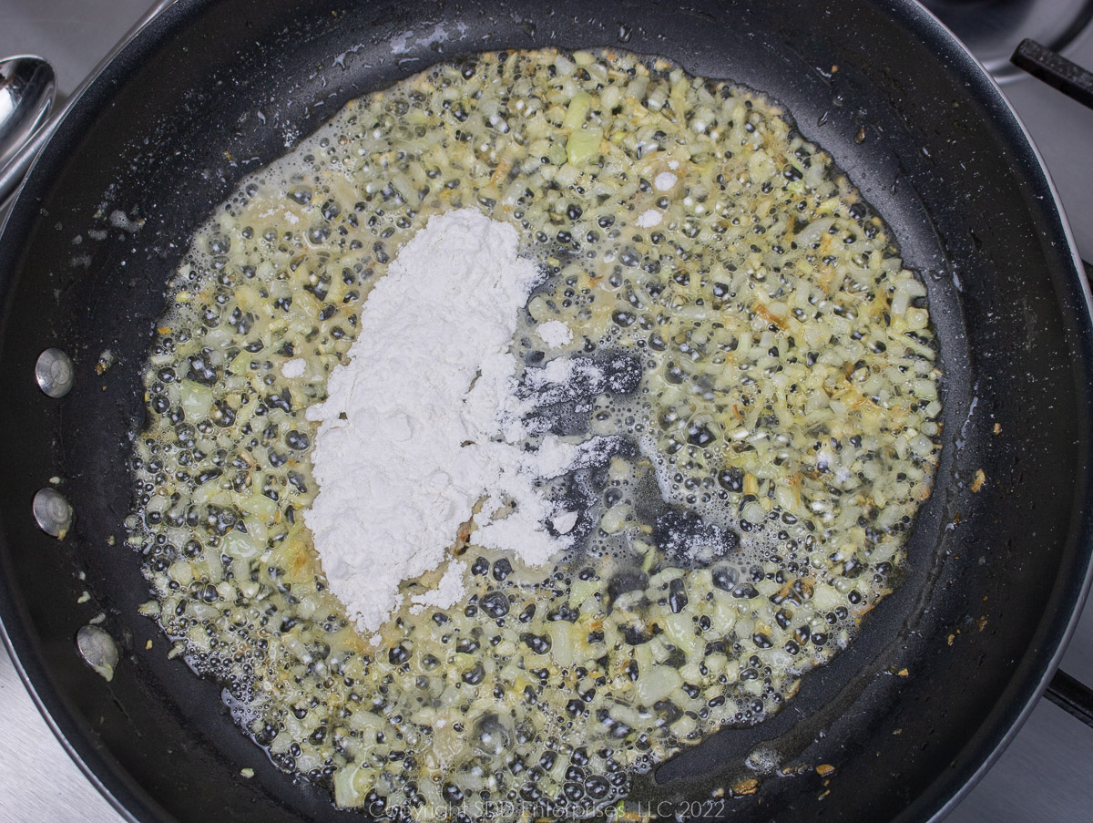 AP flour added to onions in butter in a sauté pan