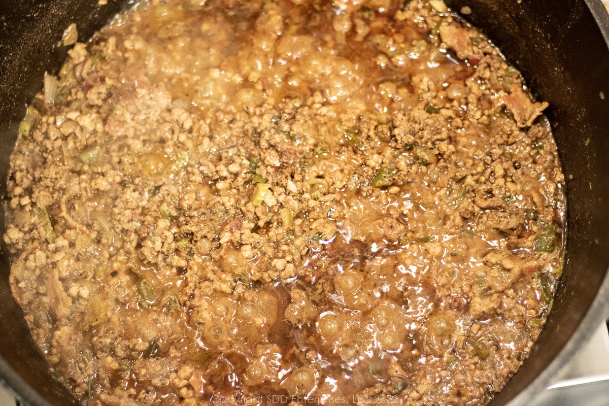 stock reducing in the meat mixture in a Dutch oven