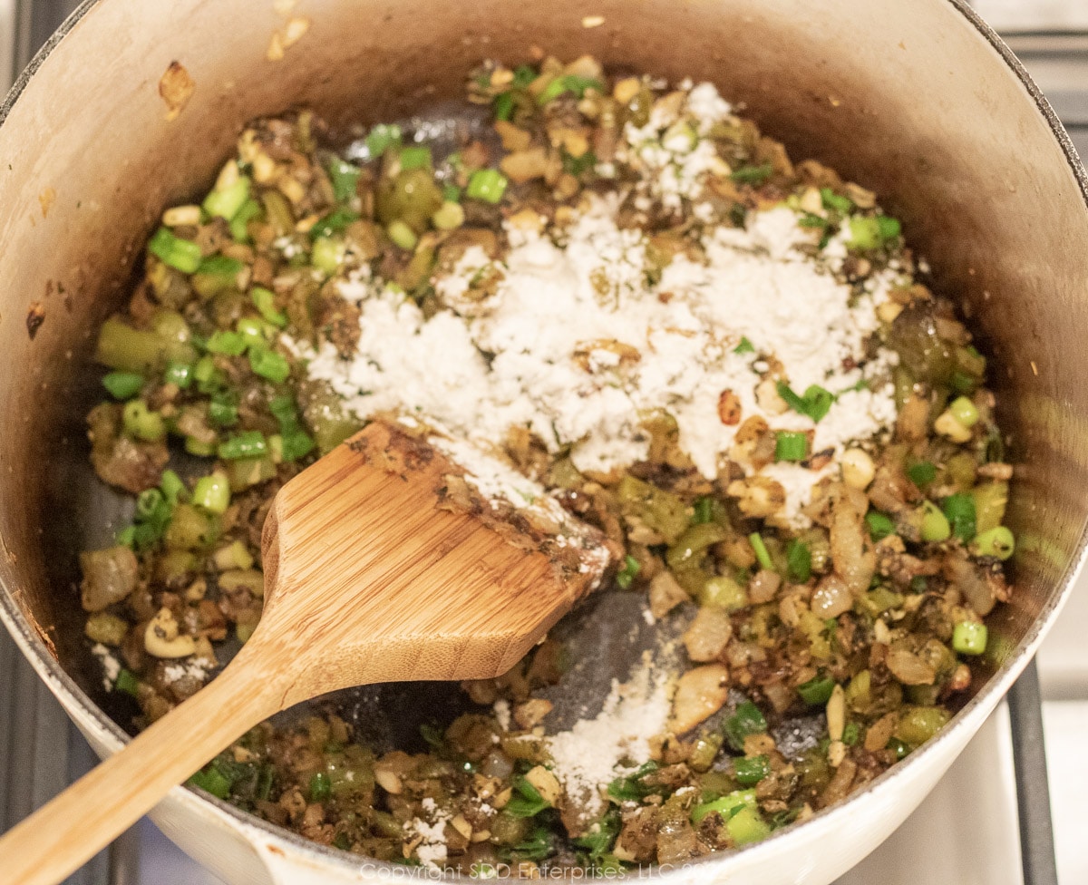 blending flour onyo sauteing vegetables in a Dutch oven