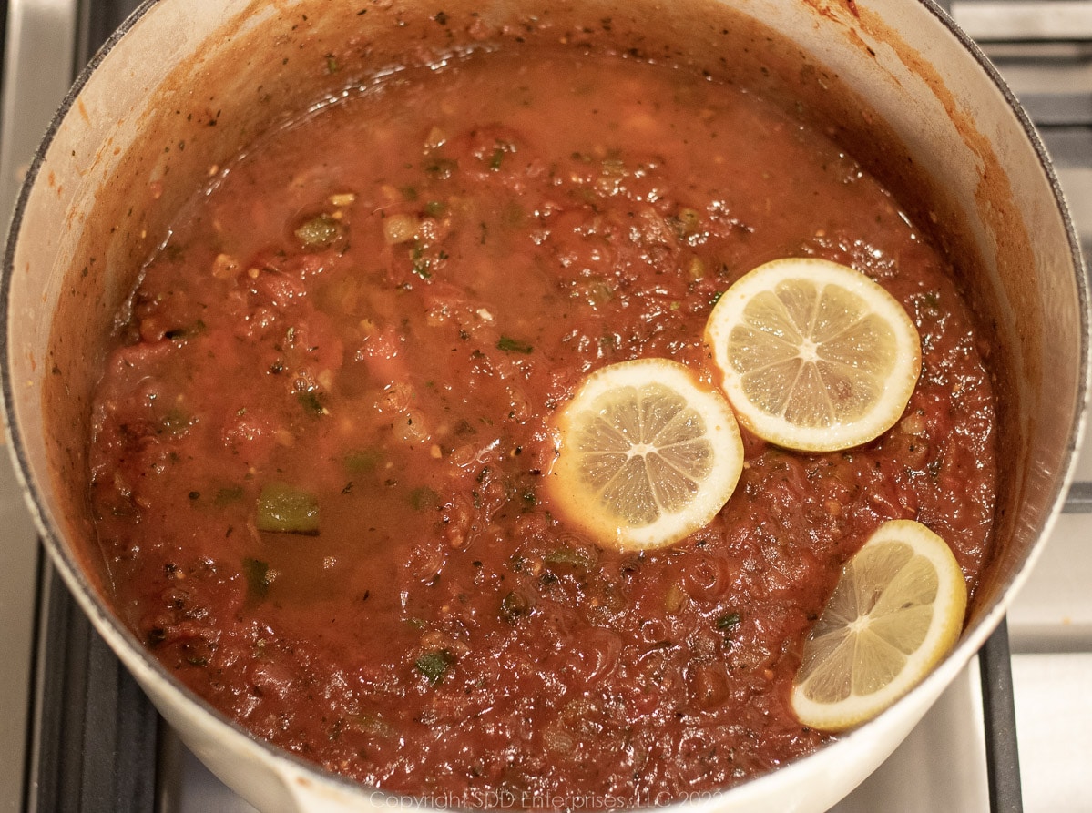 lemon juice and slices added to the simmering sauce in a Dutch oven