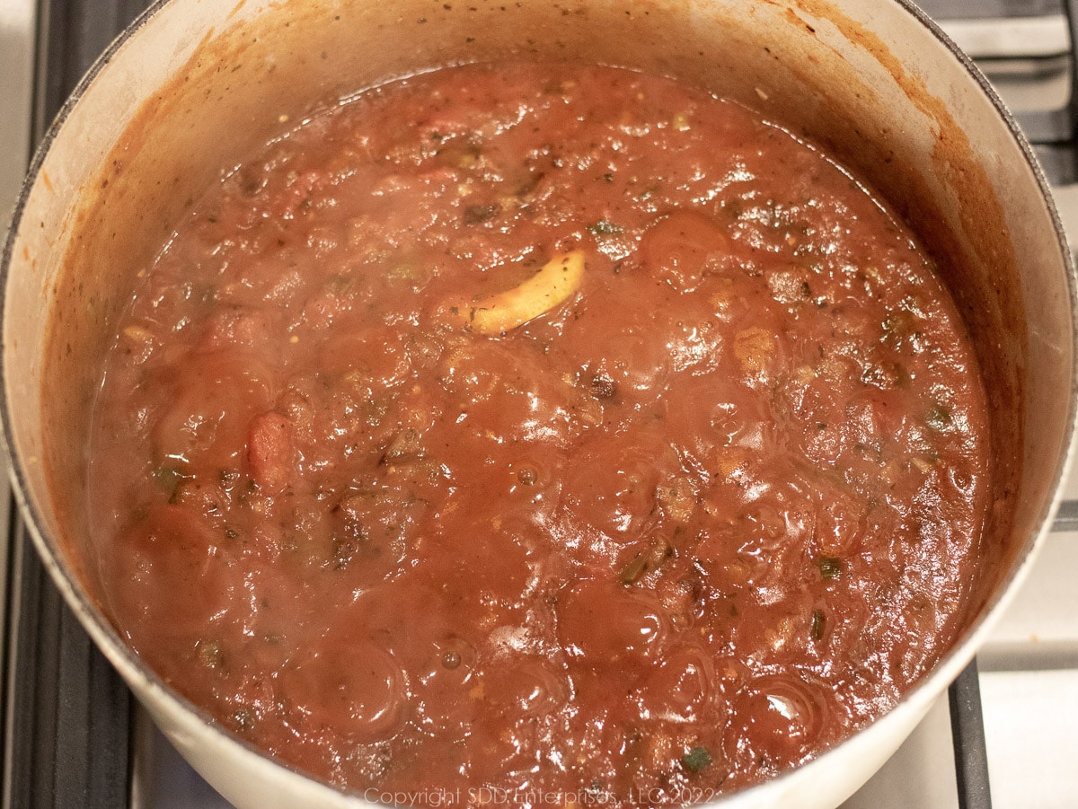 simmering creole sauce in a Dutch oven
