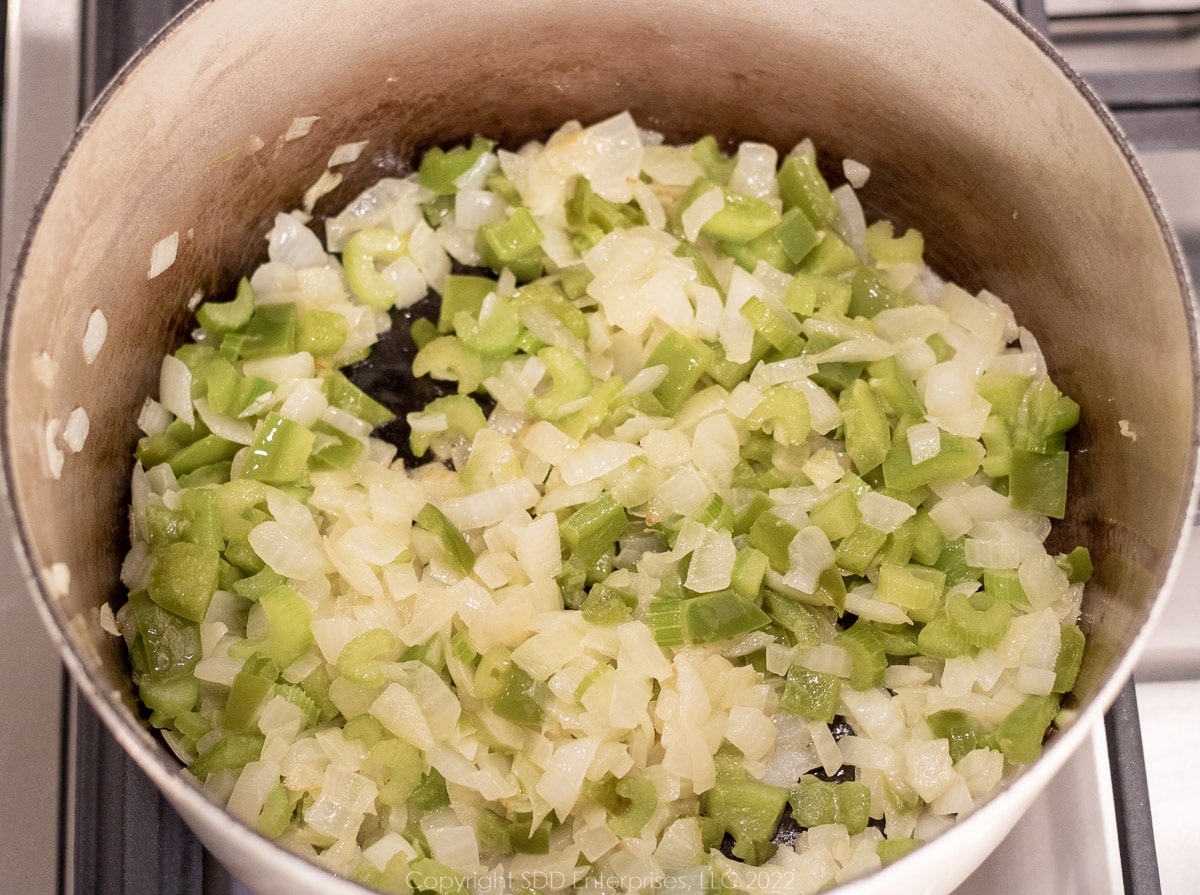 onions, peppers and celery sautéing in a Dutch oven