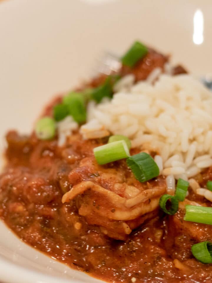 shrimp creole with rice and garnish in a white bowl