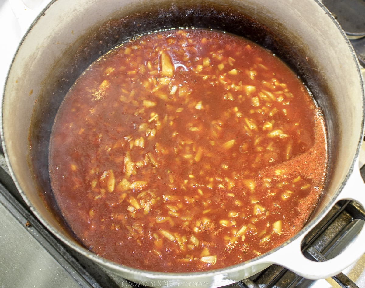 bbq sauce simmering in a Dutch oven