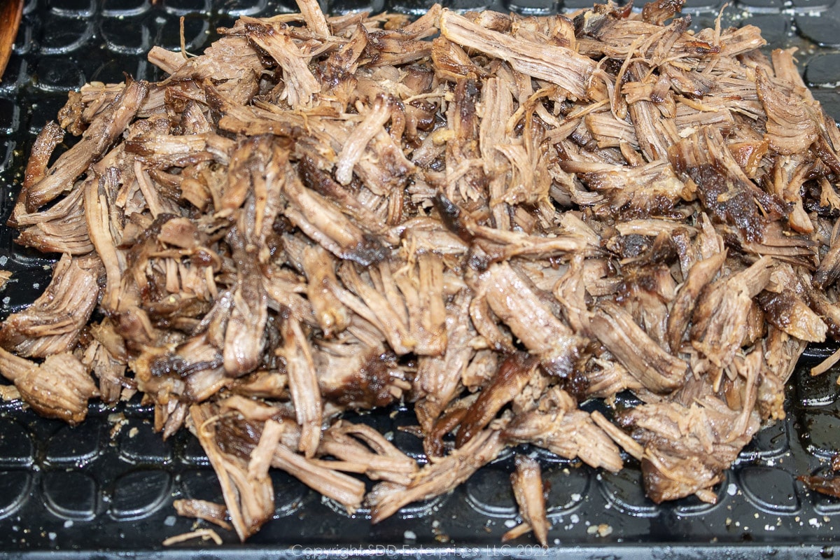 shredded beer-braised beef chuck roast on a platter