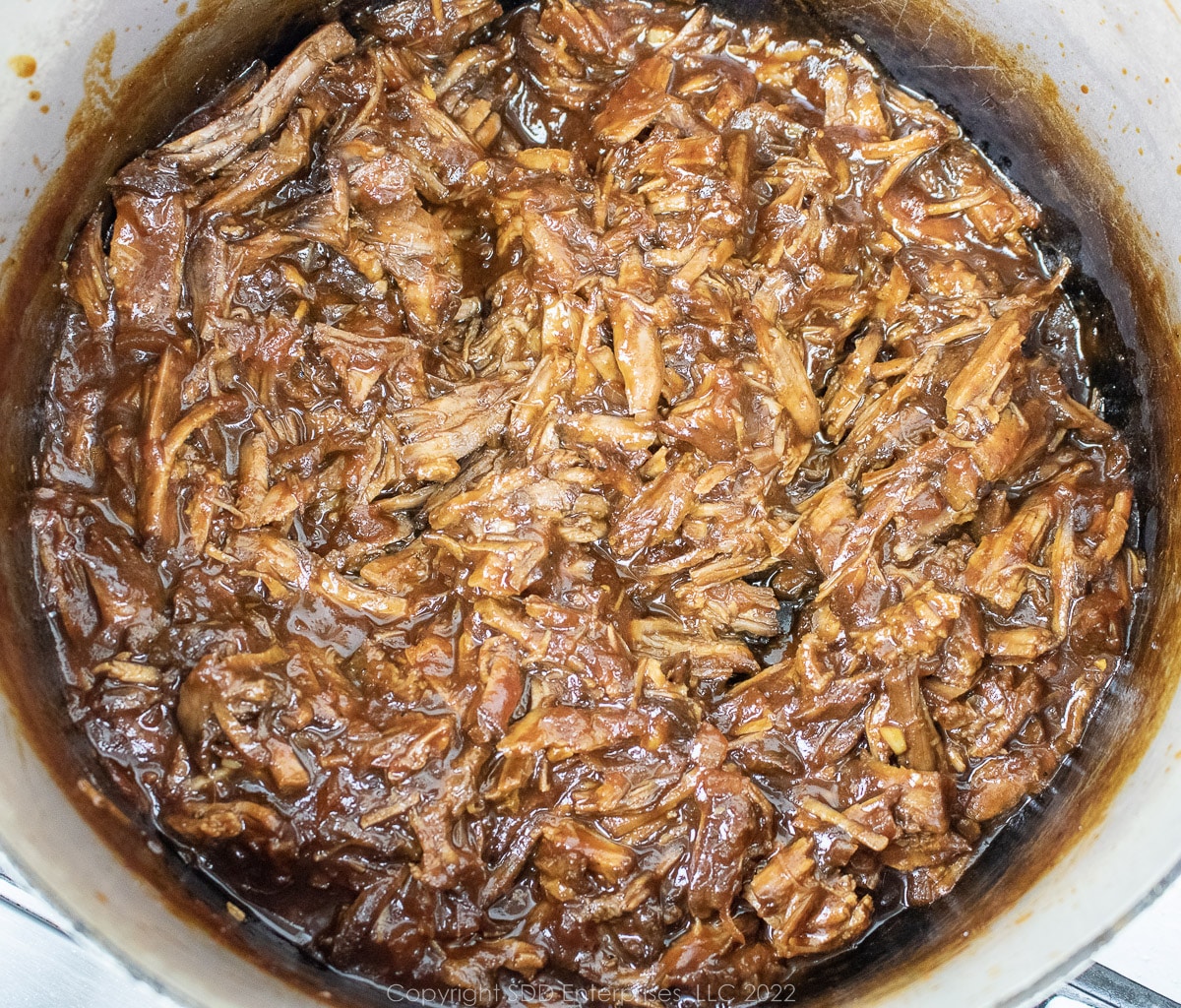 simmering bbq beef in a Dutch oven