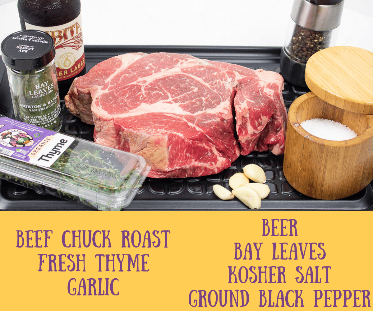 beef chuck roast with seasonings on a black platter