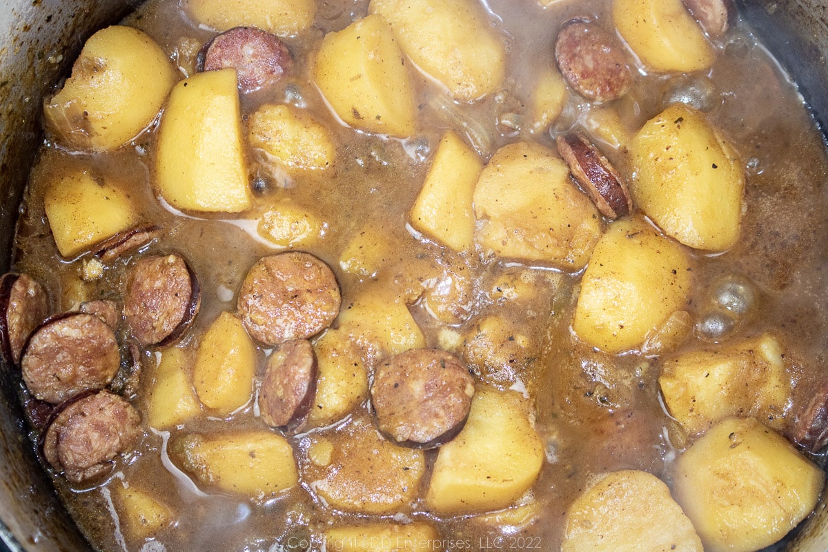 simmering smothered potatoes in a Dutch oven