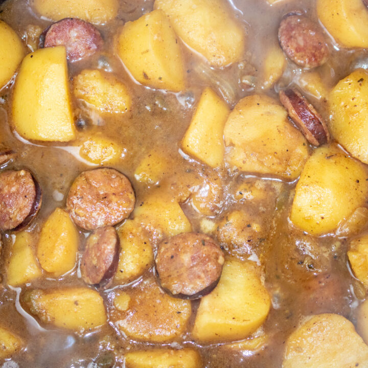 simmering smothered potatoes in a Dutch oven