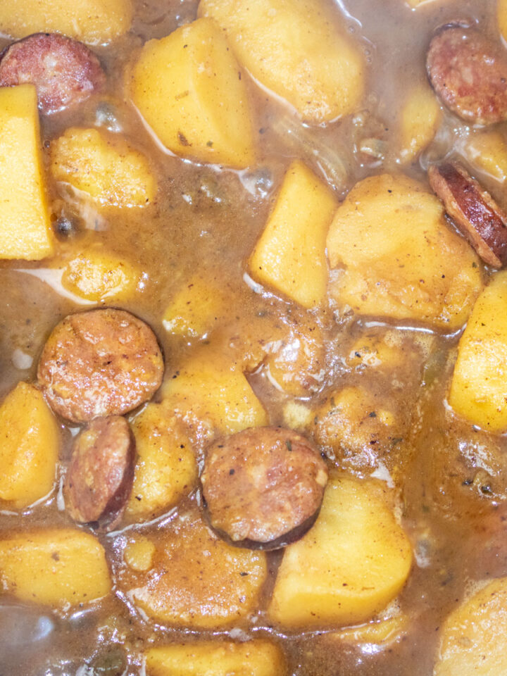 simmering smothered potatoes in a Dutch oven