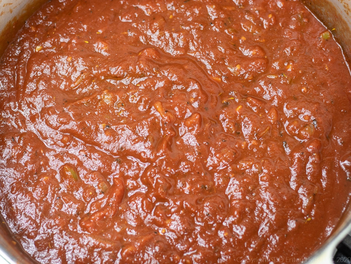 simmering tomato sauce in a Dutch oven