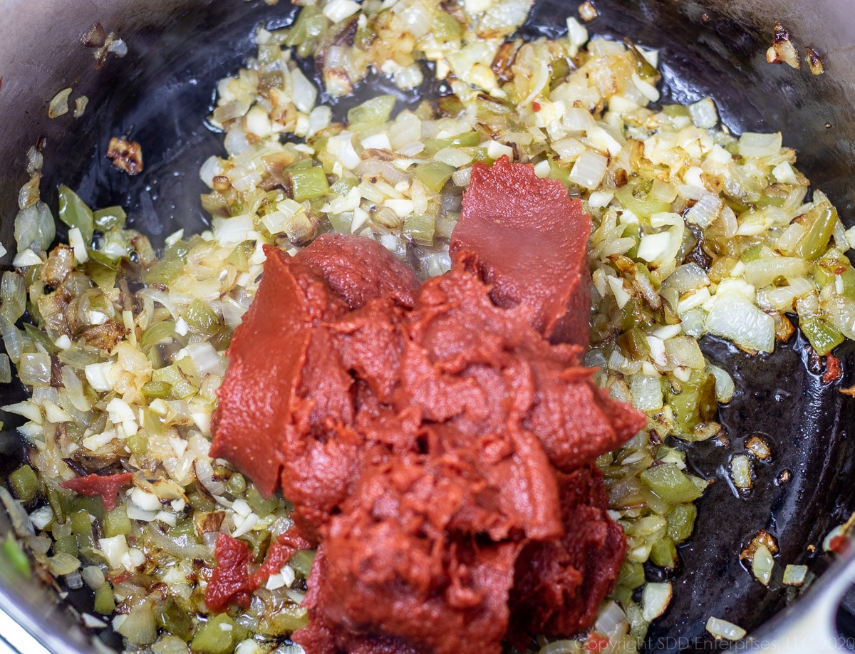 tomato paste added to sautéed vegetables in a Dutch oven