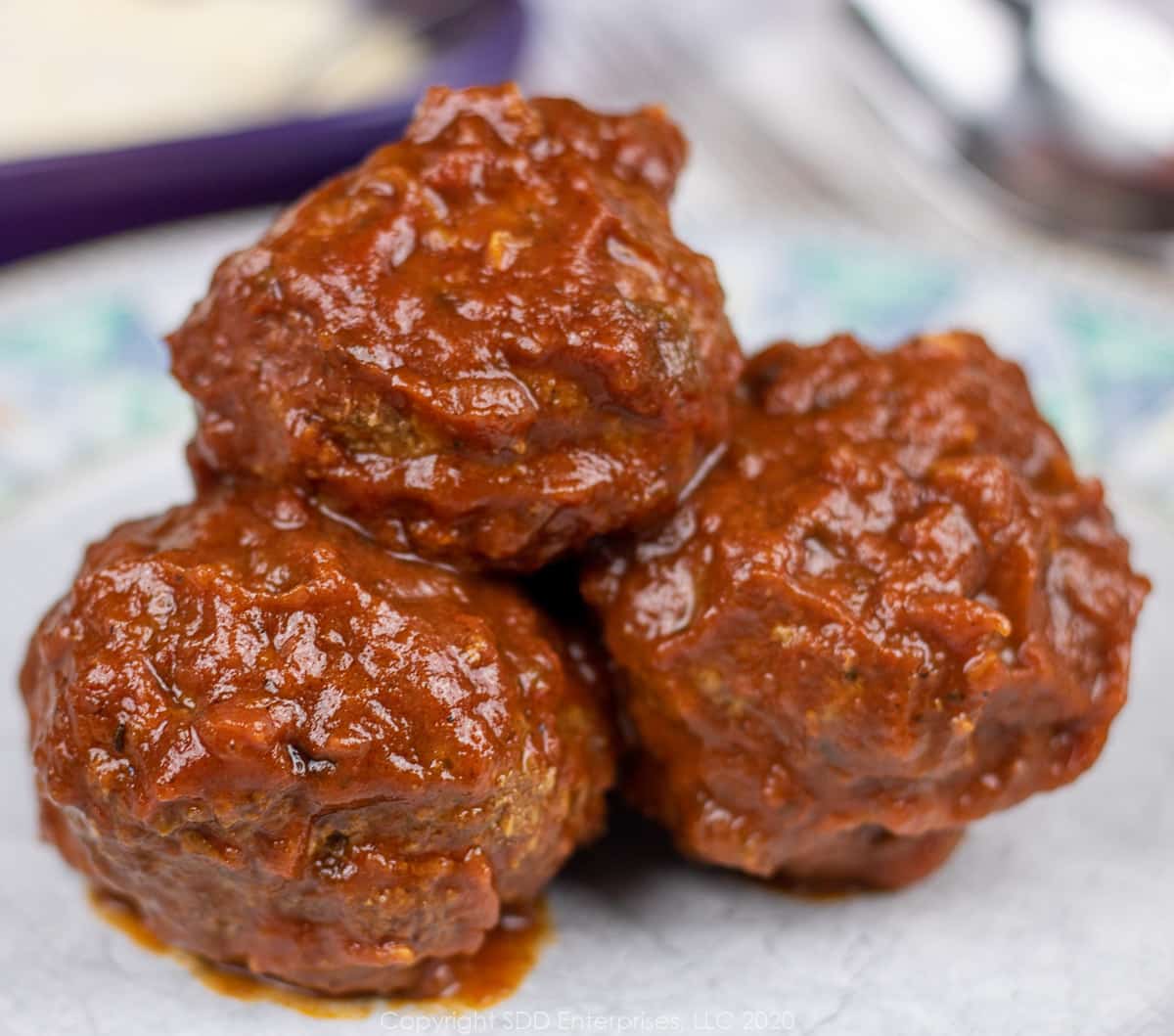 three meatballs on a plate