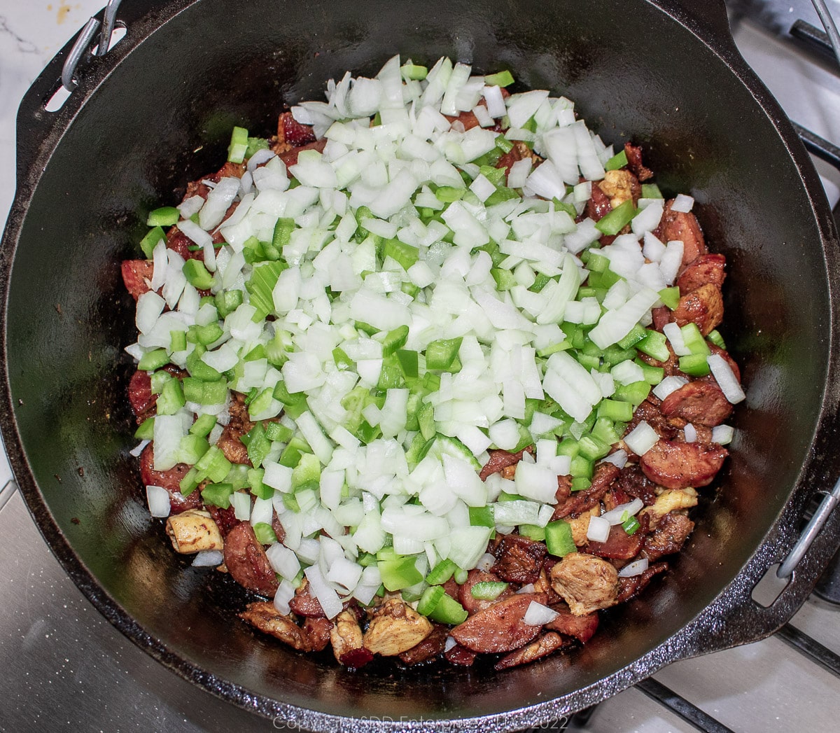 the trinity added to frying meats in a Dutch oven