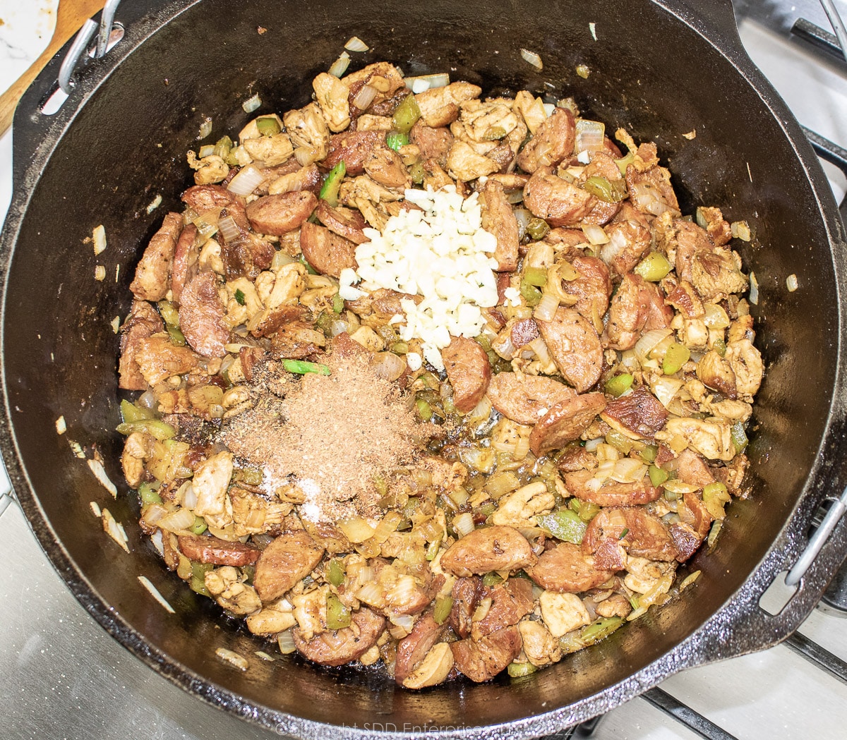 aromatics added to meats and vegetables in a Dutch oven