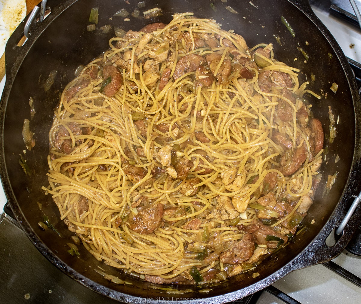 spaghetti cooking with other ingredients in a  Dutch oven