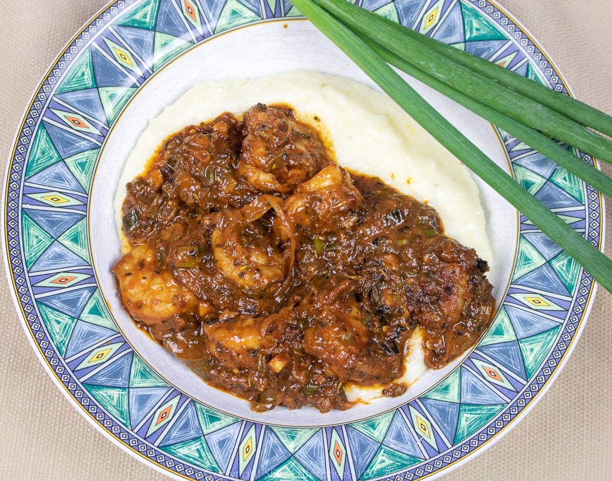 shrimp and grits in a blue green bowl