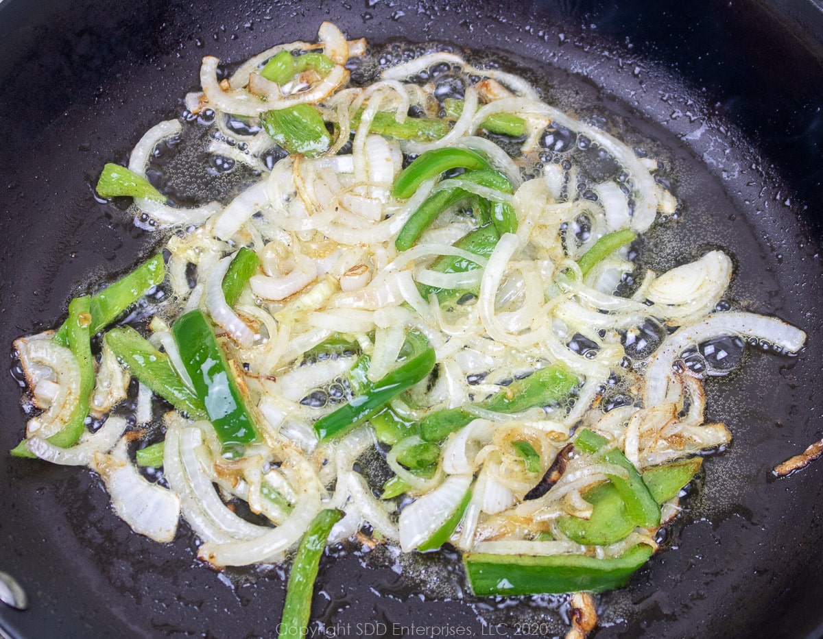 onions and peppers sautéing in butter