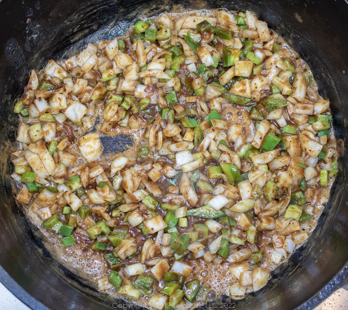 The trinity browning in a roux in a Dutch oven