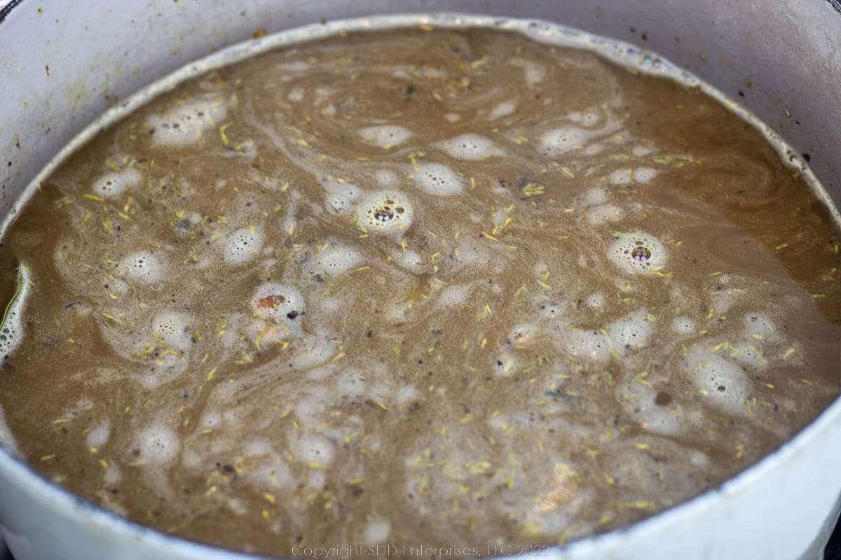 stock added to seasonings on a Dutch oven