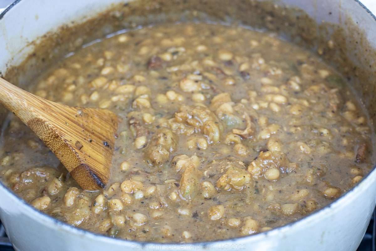 white beans ans shrimp simmering in a Dutch oven