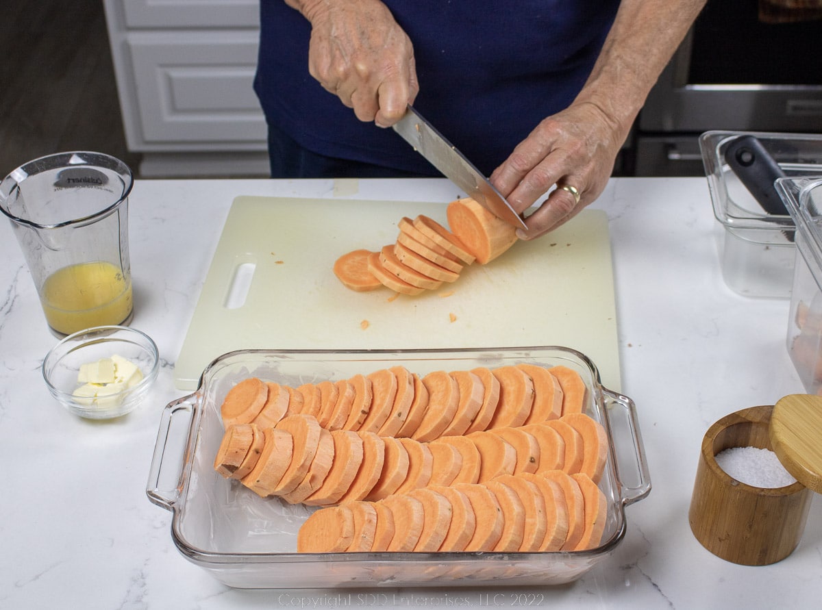 slicing sweet potatoes and placing in a baking dish