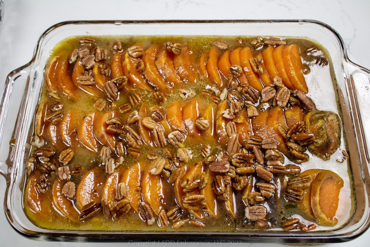 sweet potaoes in cane syrup utter sauce in a baking dish