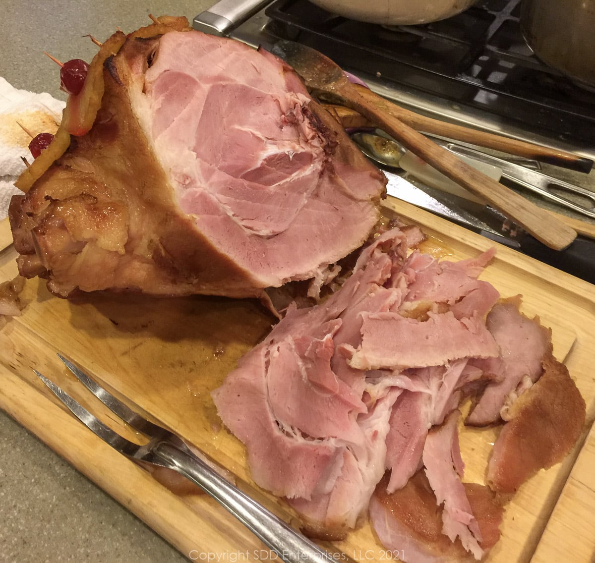 carved ham on a cutting board