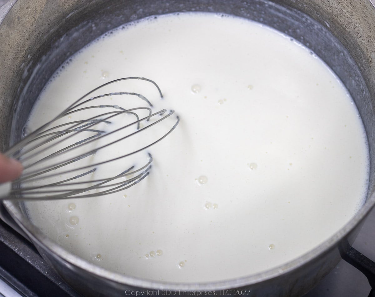 whisking bechamel sauce