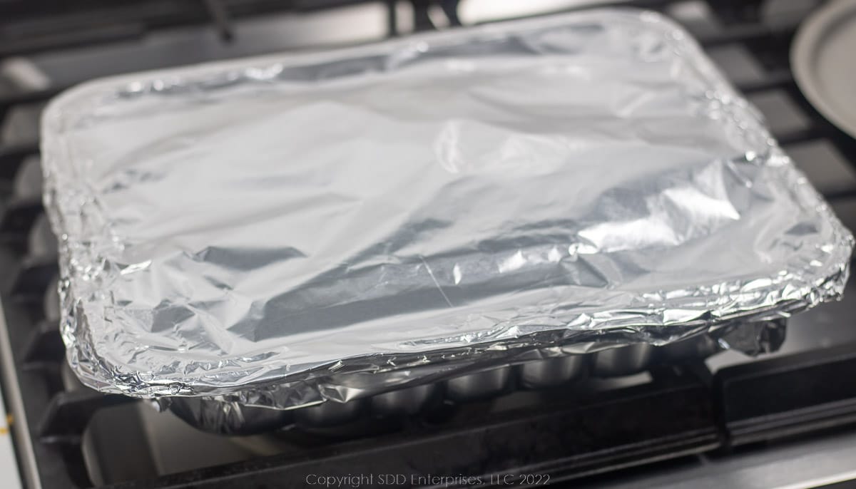a pan covered with aluminum foil ready for the oven