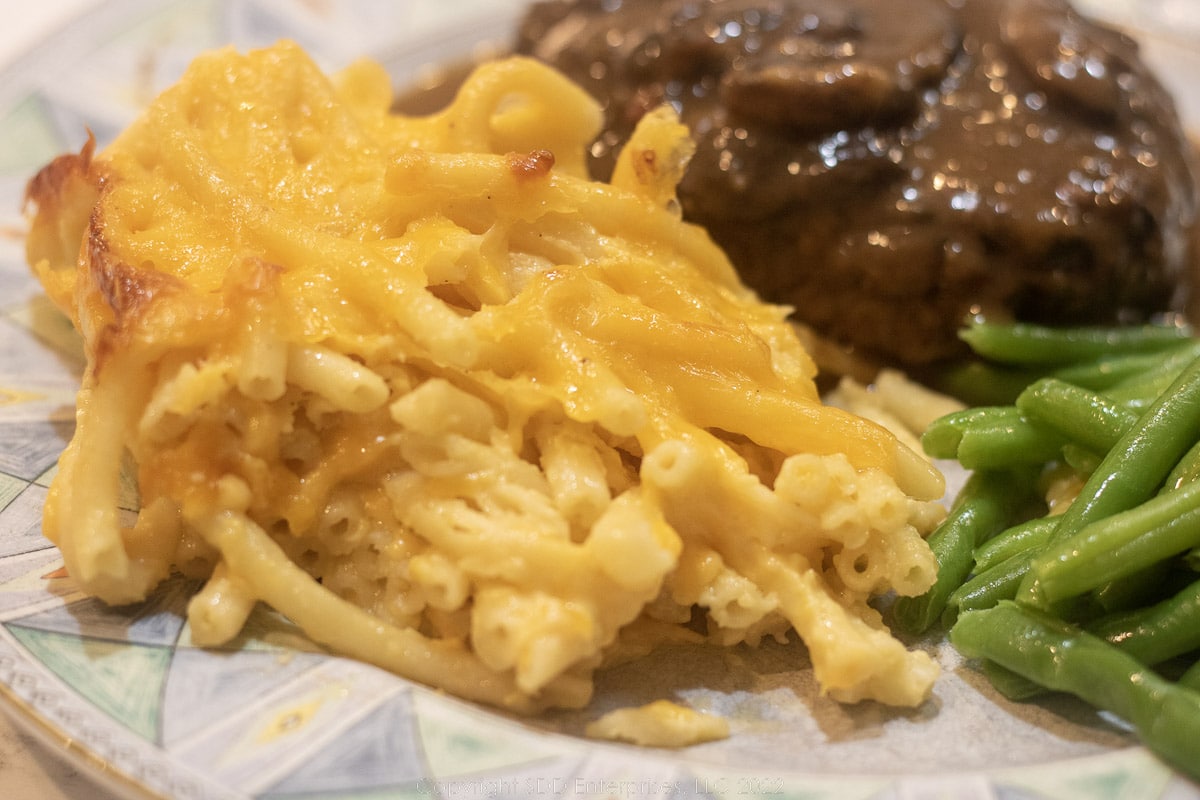 mac and cheese on a plate with hamburger steak