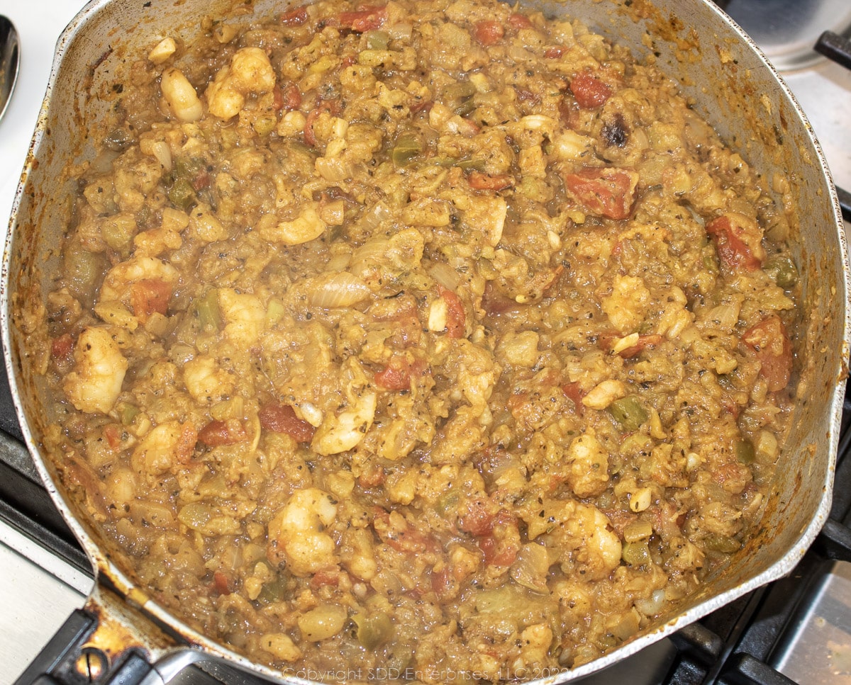 simmering vegetables and shrimp in a frying pan