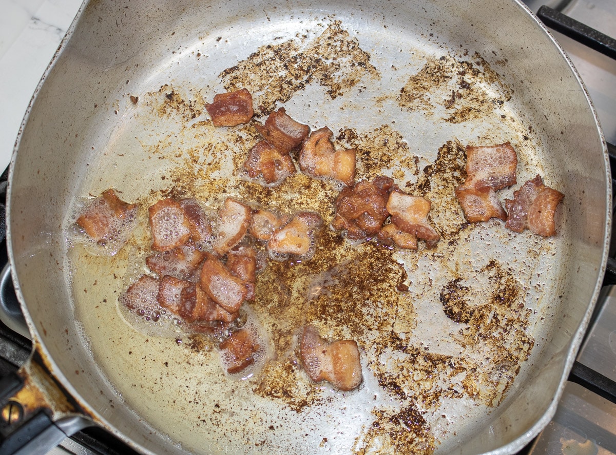 frying bacon in a frying pan