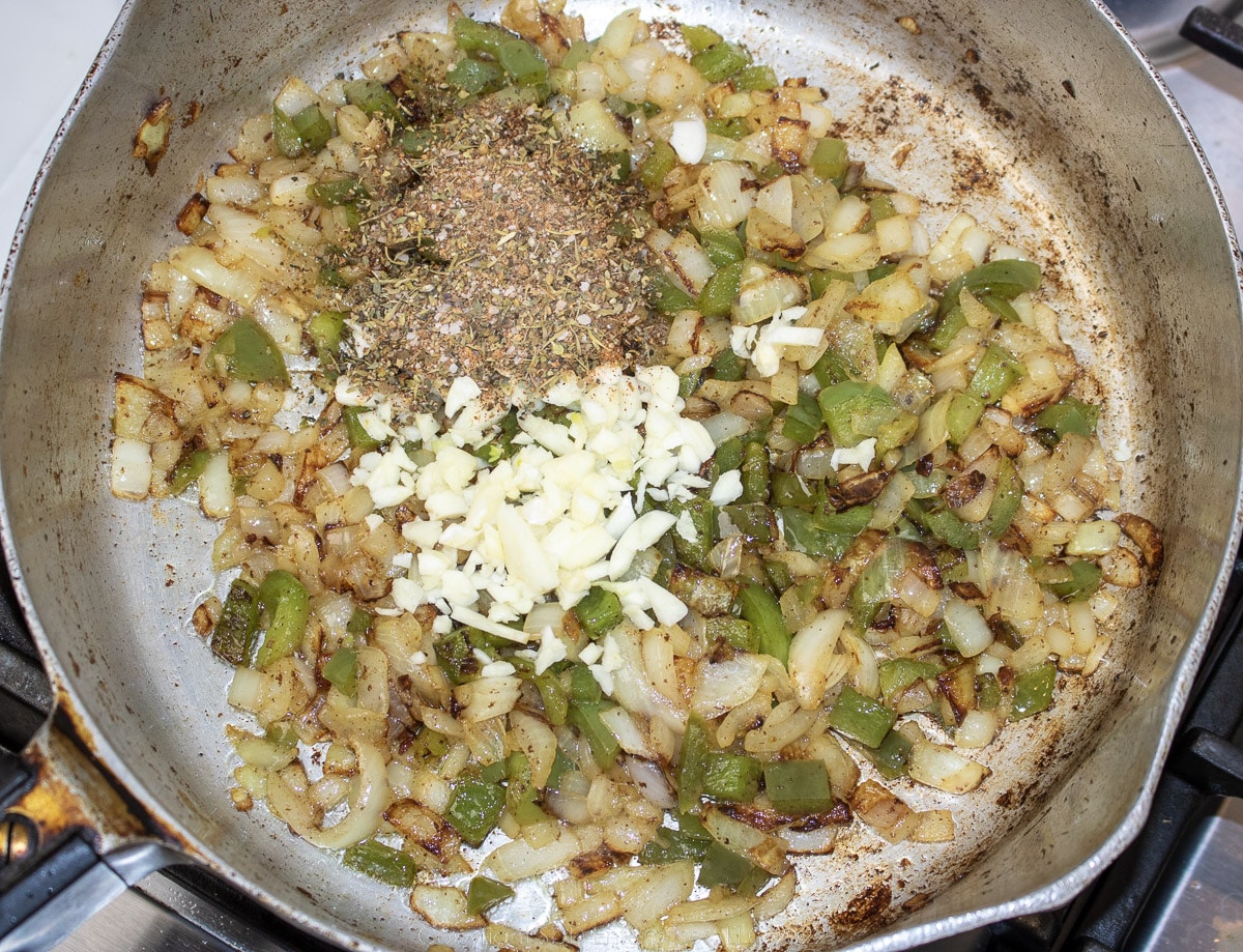 seasonings added to frying onions and bell peppers