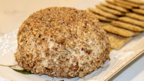 cheese ball on a platter with crackers