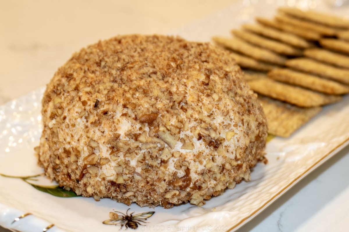 cheese ball on a platter with crackers